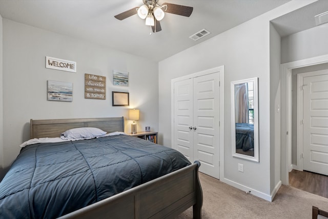 bedroom with light carpet, a closet, and ceiling fan