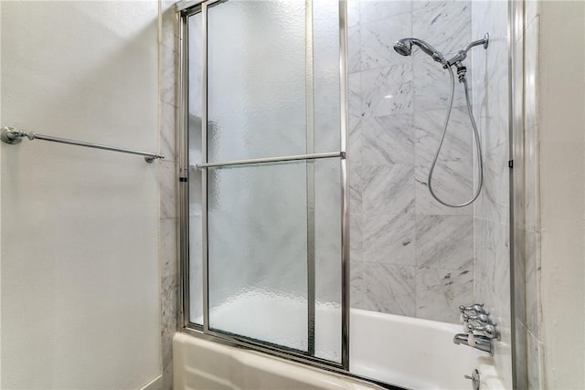 bathroom featuring combined bath / shower with glass door