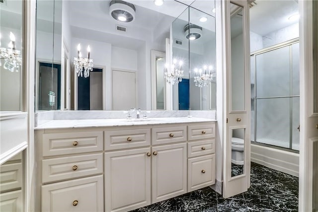 full bathroom with vanity, toilet, a notable chandelier, and bath / shower combo with glass door