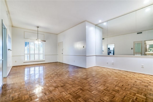 spare room featuring parquet floors and ceiling fan