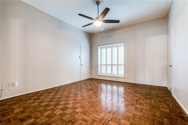 spare room featuring dark parquet floors and ceiling fan