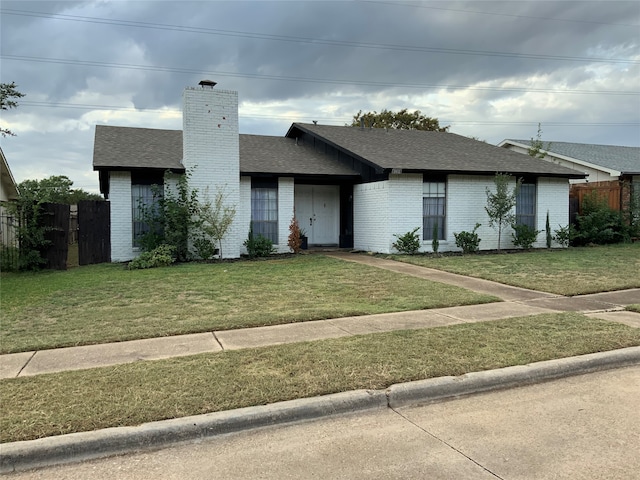 ranch-style house with a front lawn