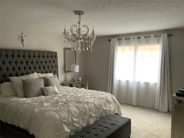 bedroom featuring a chandelier and carpet