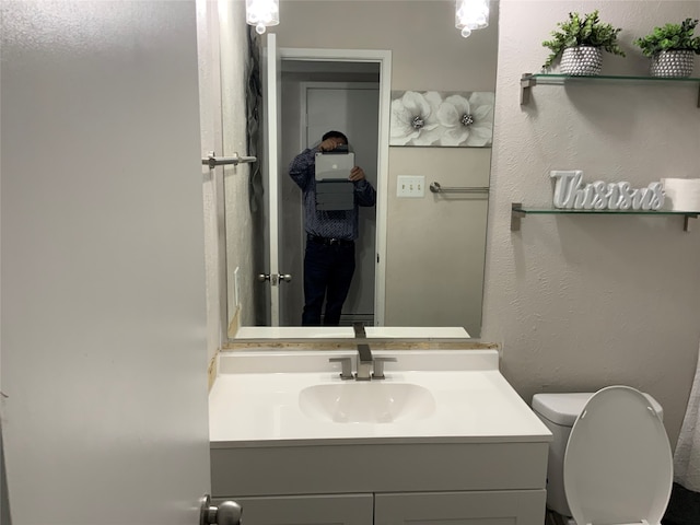 bathroom featuring vanity and toilet