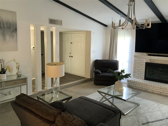 living room with a chandelier, a brick fireplace, and vaulted ceiling with beams