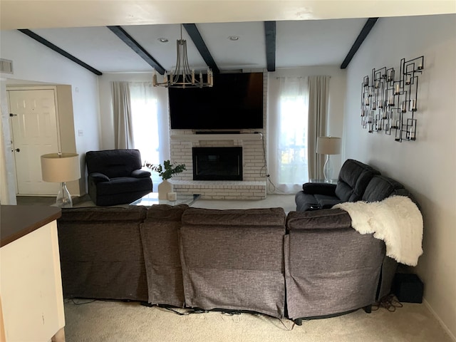 living room featuring a notable chandelier, lofted ceiling with beams, carpet flooring, and a brick fireplace