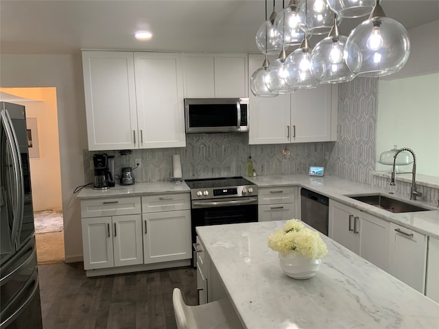 kitchen featuring appliances with stainless steel finishes, white cabinetry, sink, and dark hardwood / wood-style floors