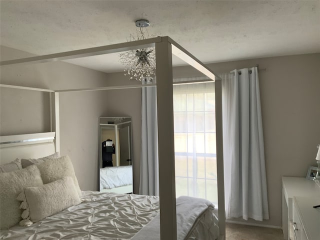 bedroom featuring carpet and a textured ceiling