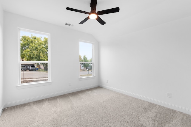 unfurnished room with ceiling fan, light colored carpet, and vaulted ceiling