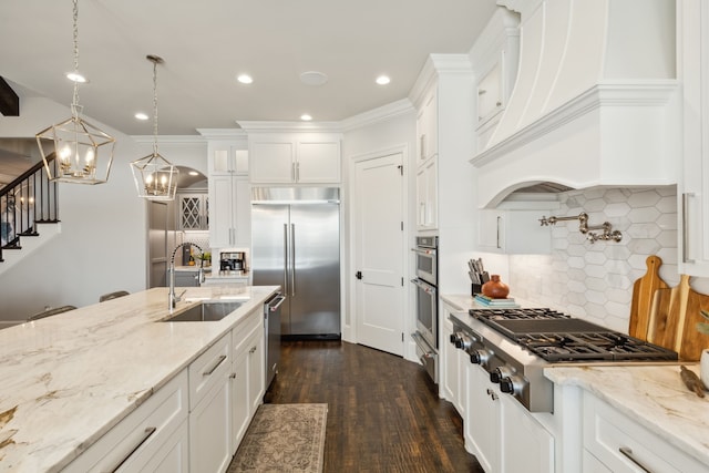 kitchen with stainless steel appliances, dark wood-type flooring, sink, decorative light fixtures, and white cabinets