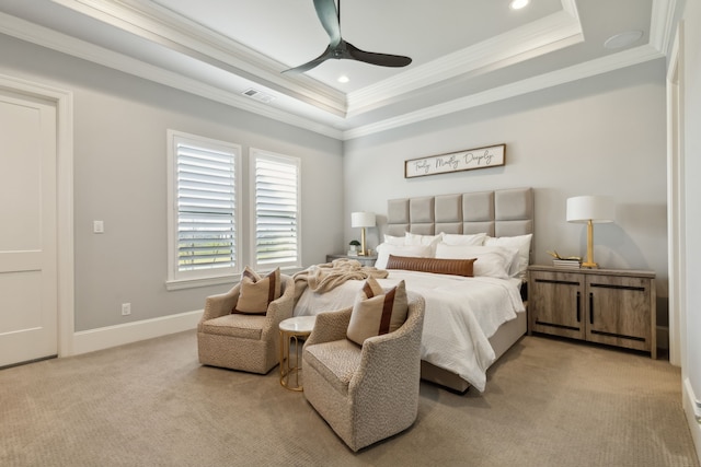 carpeted bedroom featuring a raised ceiling, ceiling fan, and ornamental molding