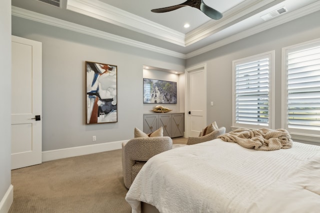 carpeted bedroom featuring a tray ceiling, ceiling fan, and ornamental molding