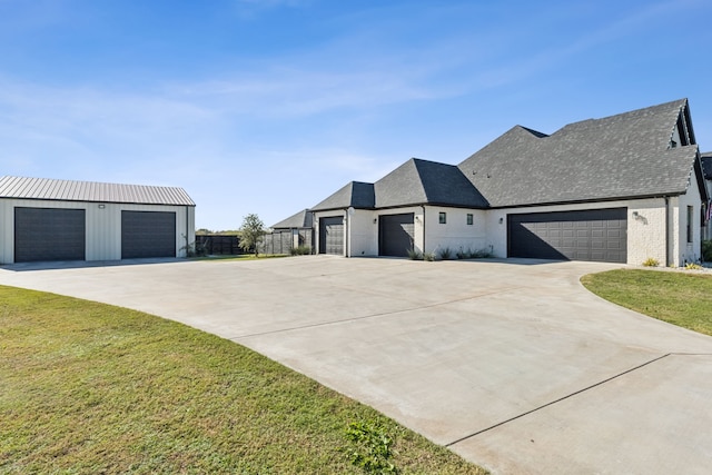 view of side of property featuring a yard and a garage