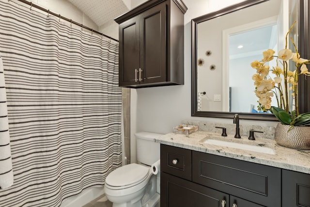 bathroom with vanity, curtained shower, toilet, and vaulted ceiling