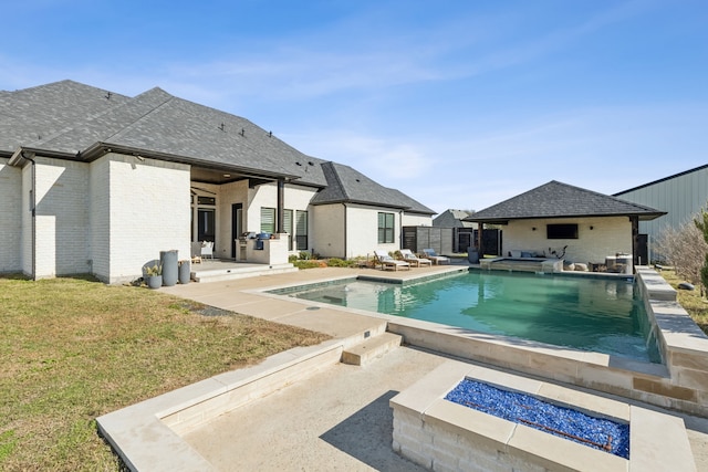 view of pool featuring a fire pit, a yard, and a patio