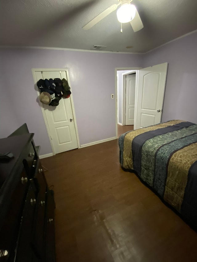 bedroom featuring dark hardwood / wood-style flooring and ceiling fan