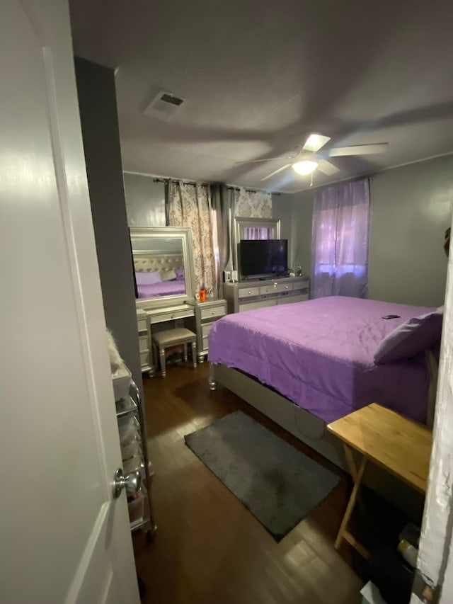 bedroom featuring ceiling fan and dark hardwood / wood-style flooring