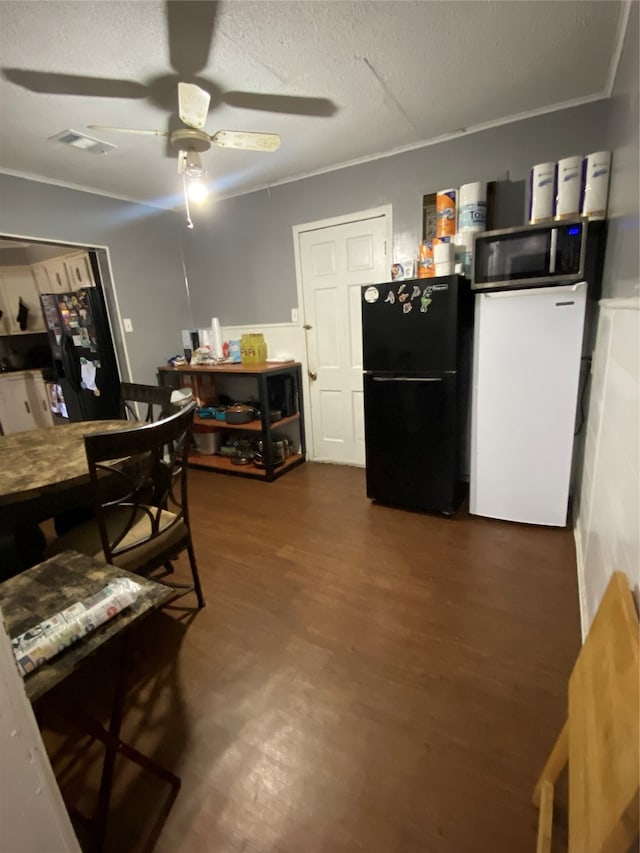 dining area featuring ceiling fan, dark hardwood / wood-style floors, a textured ceiling, and crown molding