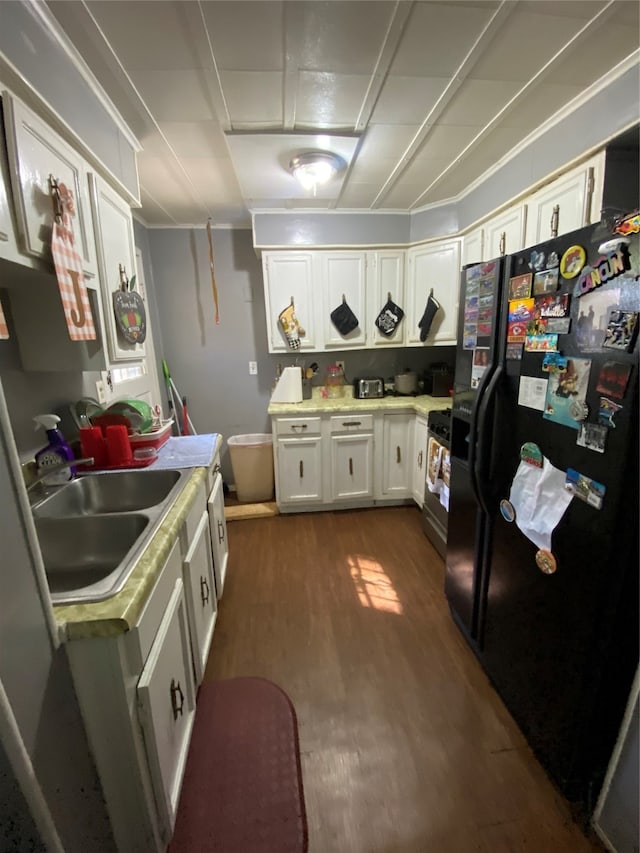 kitchen with white cabinetry, black appliances, sink, and dark hardwood / wood-style floors