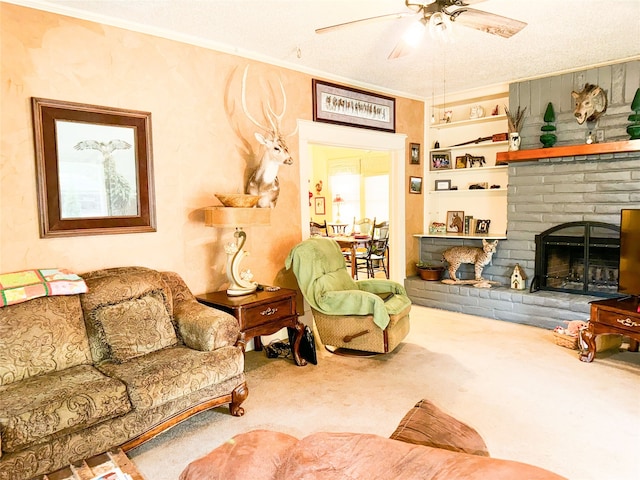 carpeted living room featuring ceiling fan, ornamental molding, a fireplace, and a textured ceiling