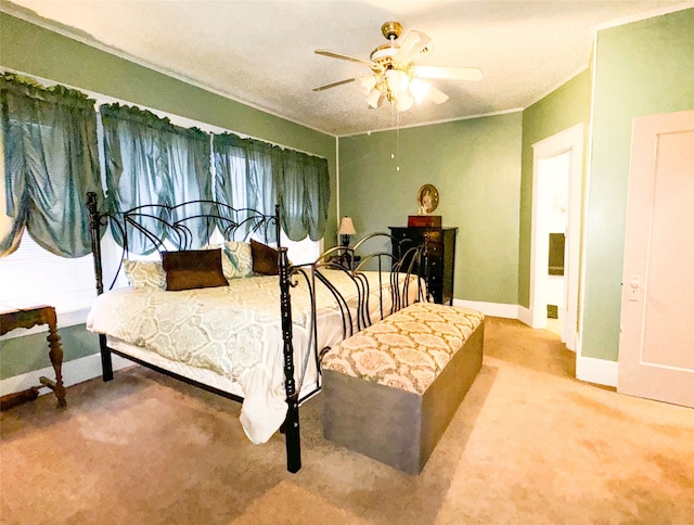 bedroom with crown molding, ceiling fan, and carpet flooring