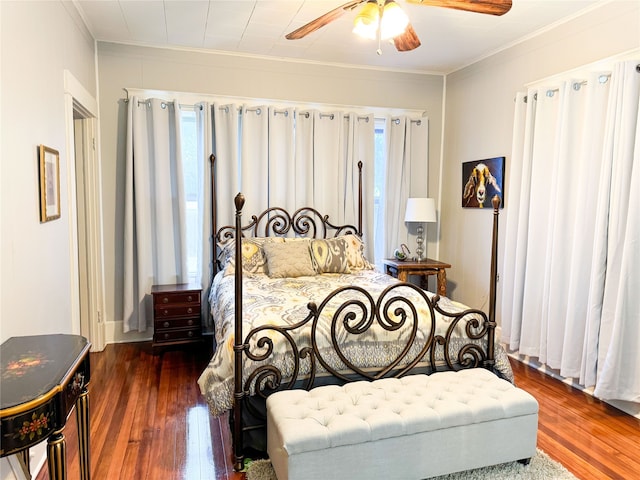 bedroom featuring ornamental molding, ceiling fan, and dark hardwood / wood-style flooring