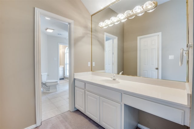 bathroom with vanity, toilet, tile patterned floors, and lofted ceiling