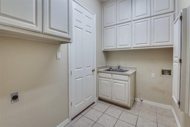 clothes washing area with hookup for a washing machine, hookup for an electric dryer, sink, cabinets, and light tile patterned floors