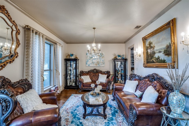 living room featuring hardwood / wood-style flooring, an inviting chandelier, and crown molding