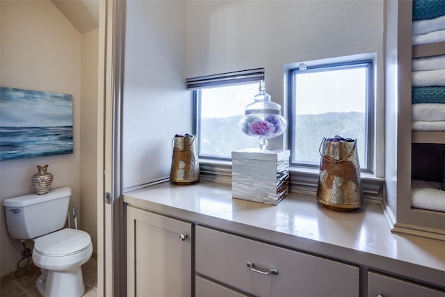 bathroom with tile patterned flooring, vanity, and toilet