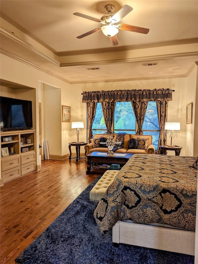 bedroom with ornamental molding, hardwood / wood-style floors, and ceiling fan