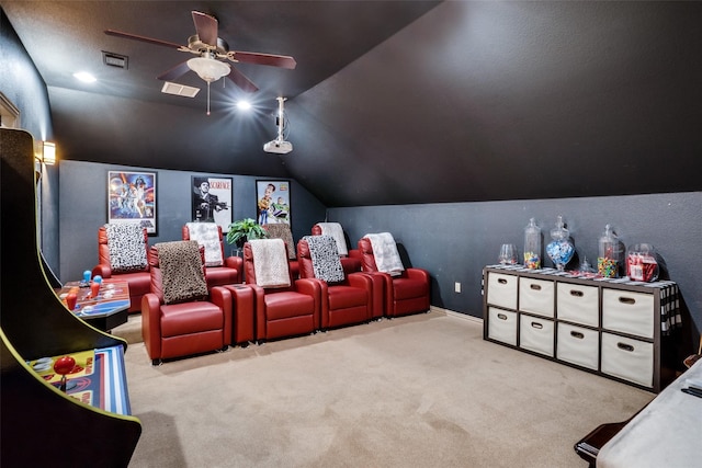 home theater room featuring light carpet, ceiling fan, and vaulted ceiling