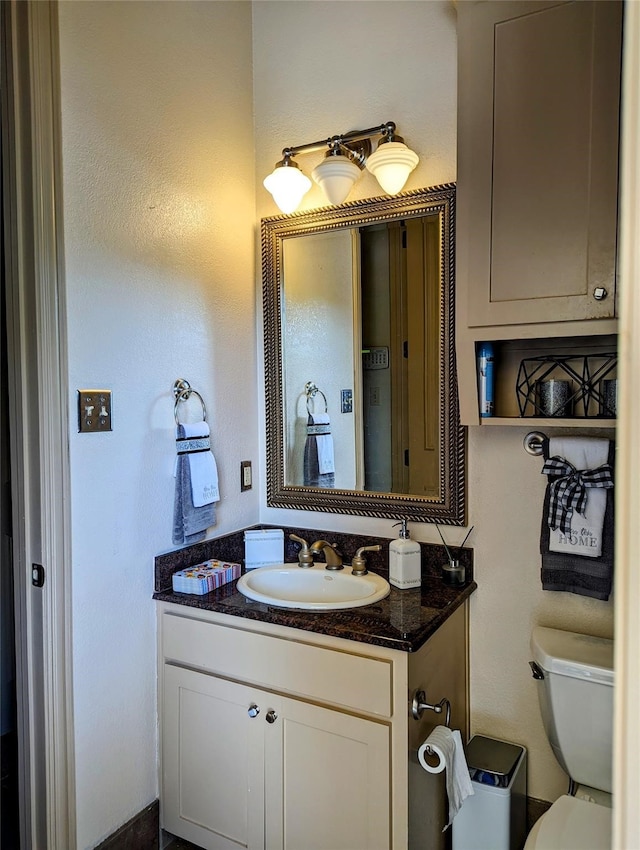 bathroom with toilet and vanity