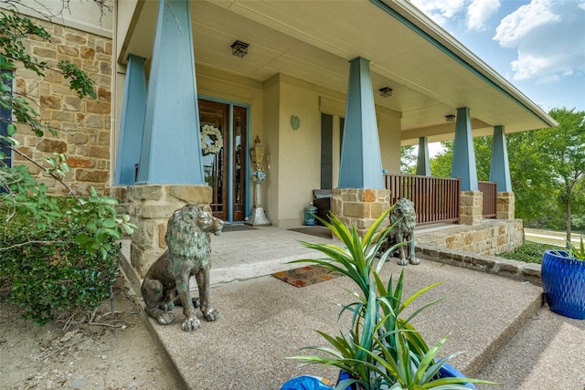 view of exterior entry with covered porch