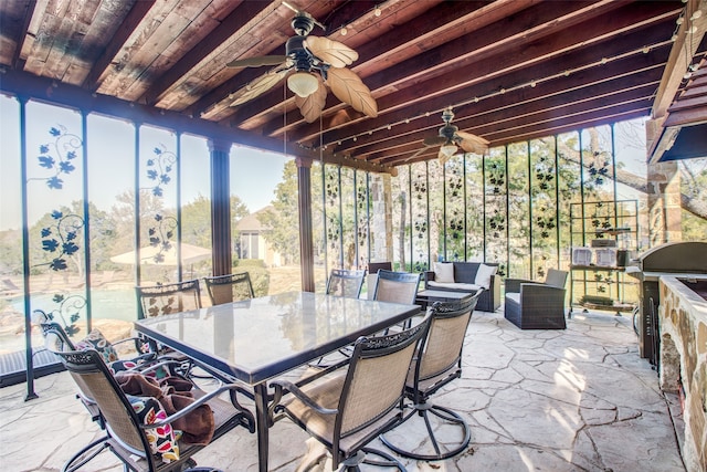 sunroom / solarium featuring ceiling fan