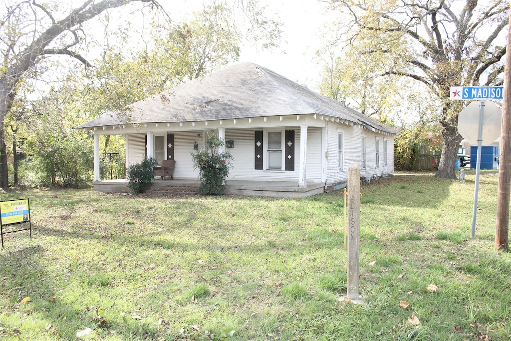 view of front of property with a front yard and a porch