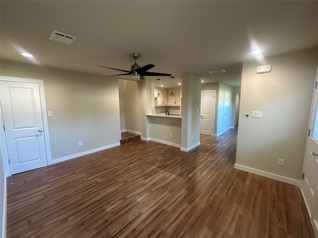 unfurnished living room with dark hardwood / wood-style floors and ceiling fan