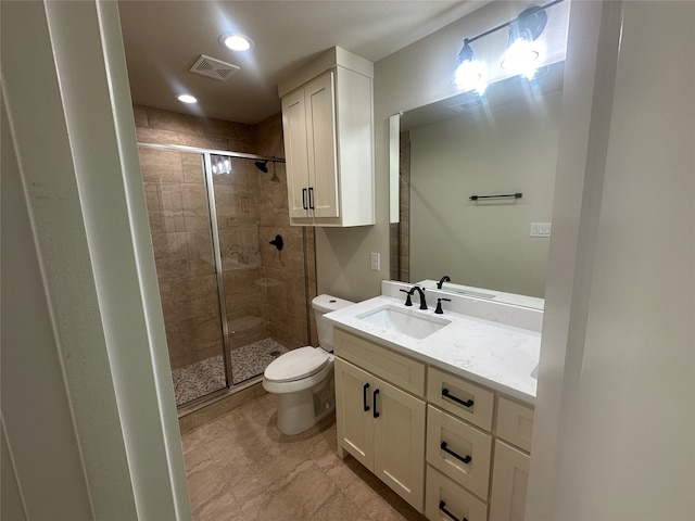 bathroom featuring walk in shower, vanity, and toilet