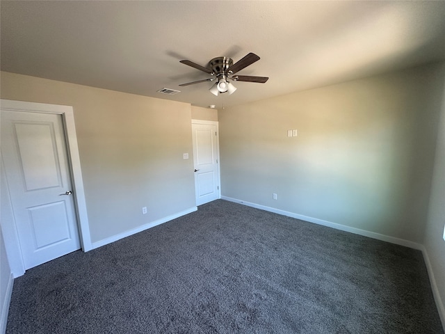 unfurnished room with dark colored carpet and ceiling fan