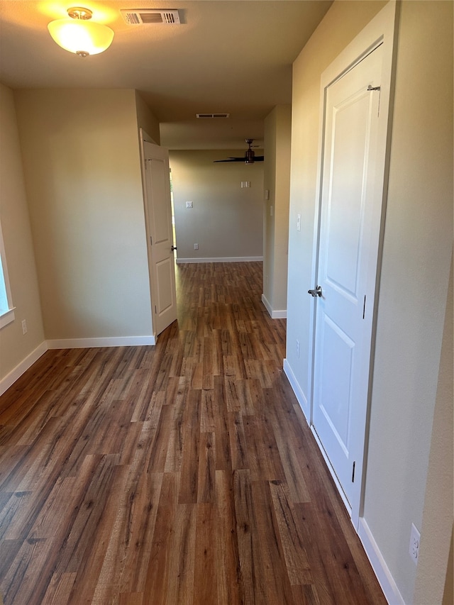 hallway with dark wood-type flooring