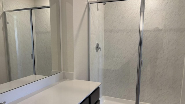 bathroom with a stall shower and vanity