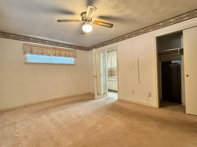 unfurnished bedroom with light carpet, a closet, and ceiling fan