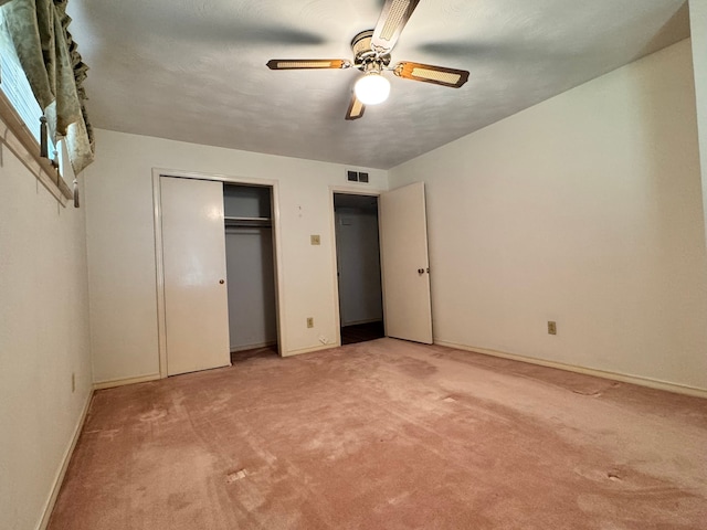 unfurnished bedroom with ceiling fan and carpet floors