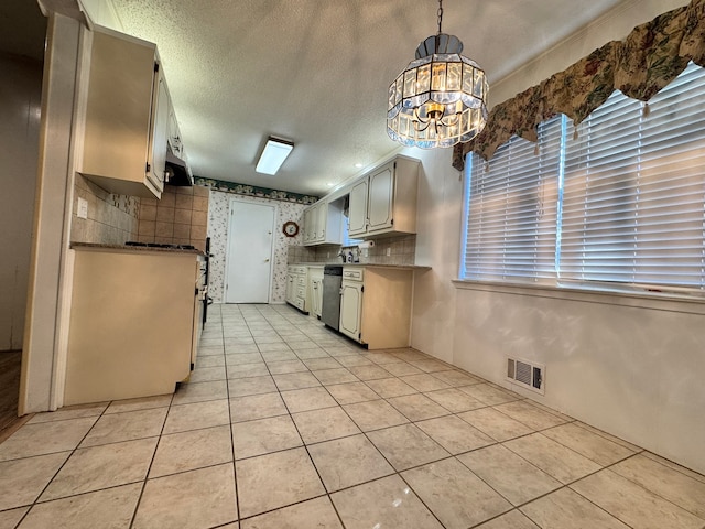 kitchen with stainless steel dishwasher, backsplash, pendant lighting, a textured ceiling, and light tile patterned flooring