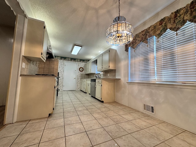 kitchen with stainless steel dishwasher, light tile patterned floors, pendant lighting, and a textured ceiling