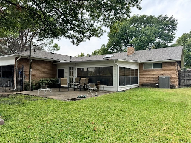 rear view of property featuring a yard and a patio