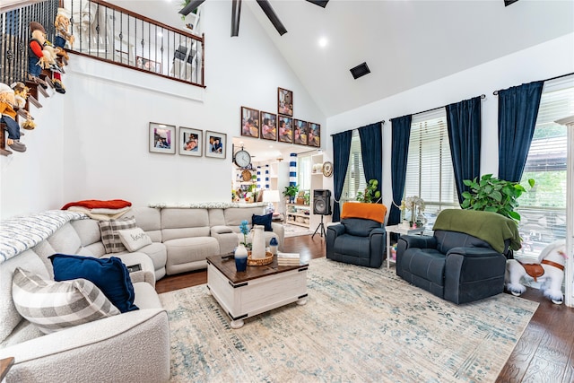 living room with hardwood / wood-style flooring, high vaulted ceiling, and ceiling fan