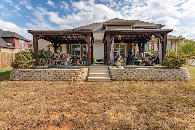 rear view of house with a gazebo and a yard