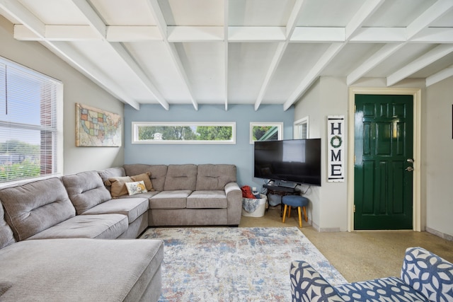 living room with plenty of natural light and beam ceiling