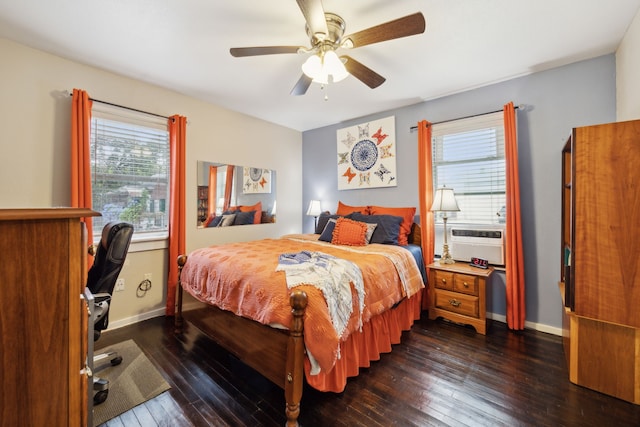 bedroom featuring ceiling fan, multiple windows, and dark hardwood / wood-style flooring